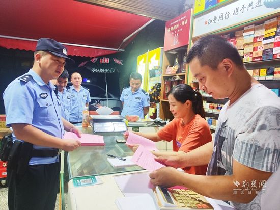 圖為崇陽(yáng)縣公安局青山派出所民警輔警在轄區(qū)沿街商鋪開展反詐宣傳.jpg.jpg